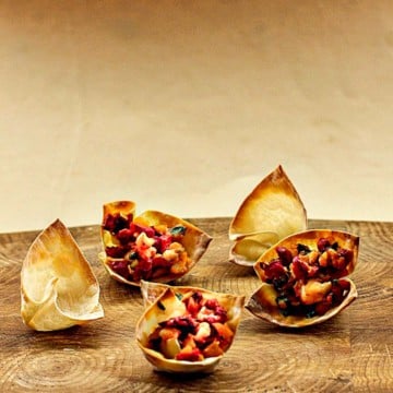shrimp wonton appetizers on a cutting board.
