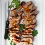 Grilled and sliced pork tenderloin served with mango chutney.