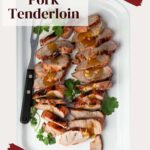 Sliced grilled pork tenderloin on a white platter.