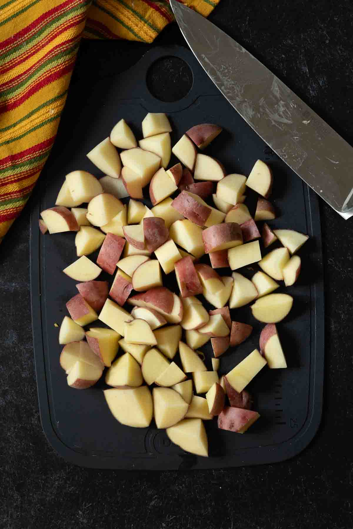 Chopped potatoes to make green chili sothered burritos with potatoes.