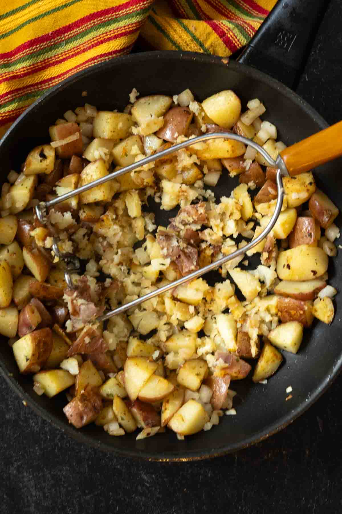 Smashing potatoes for Breakfast burritos with potatoes.