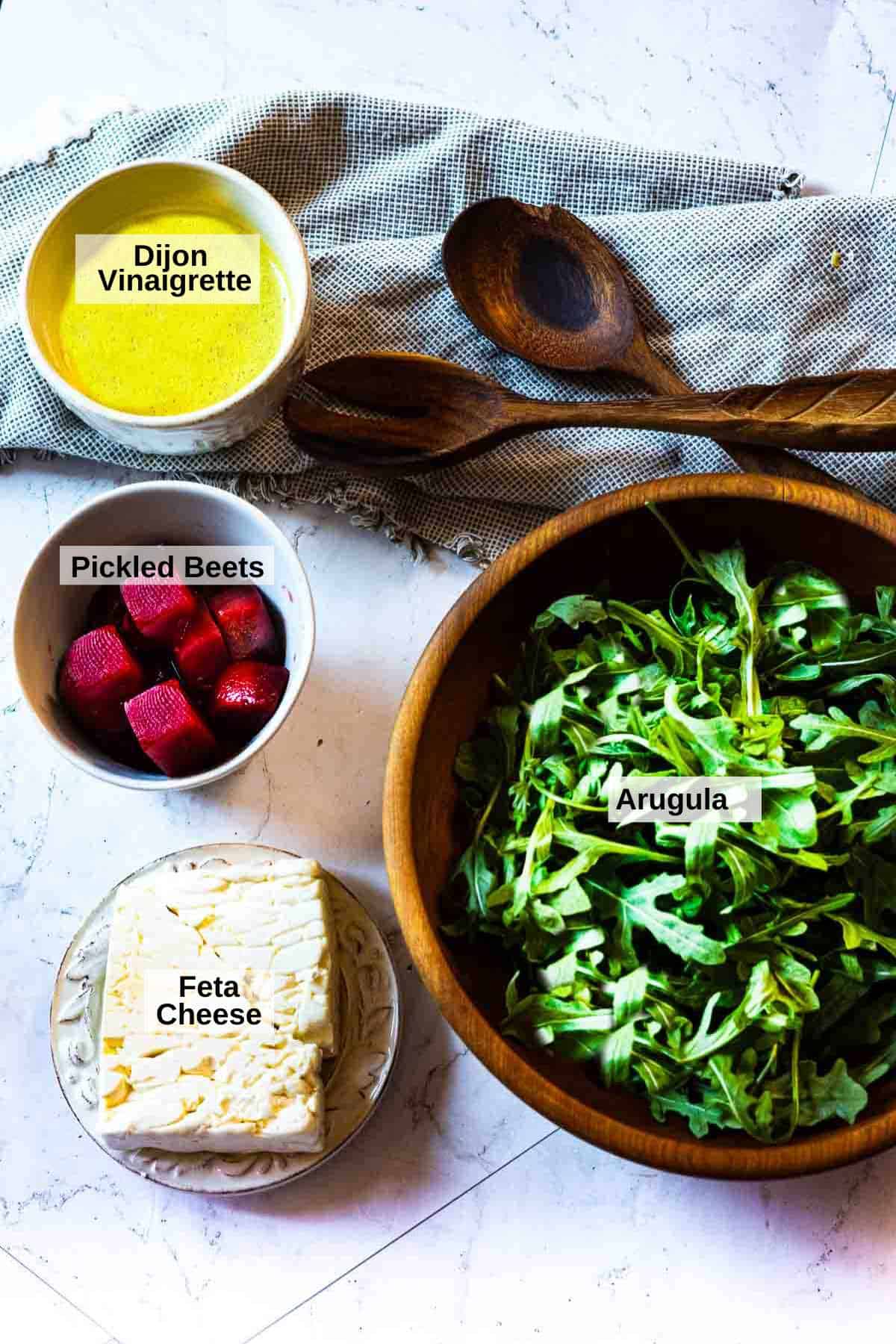 Ingredients to make pickled beet salad with feta and arugula.