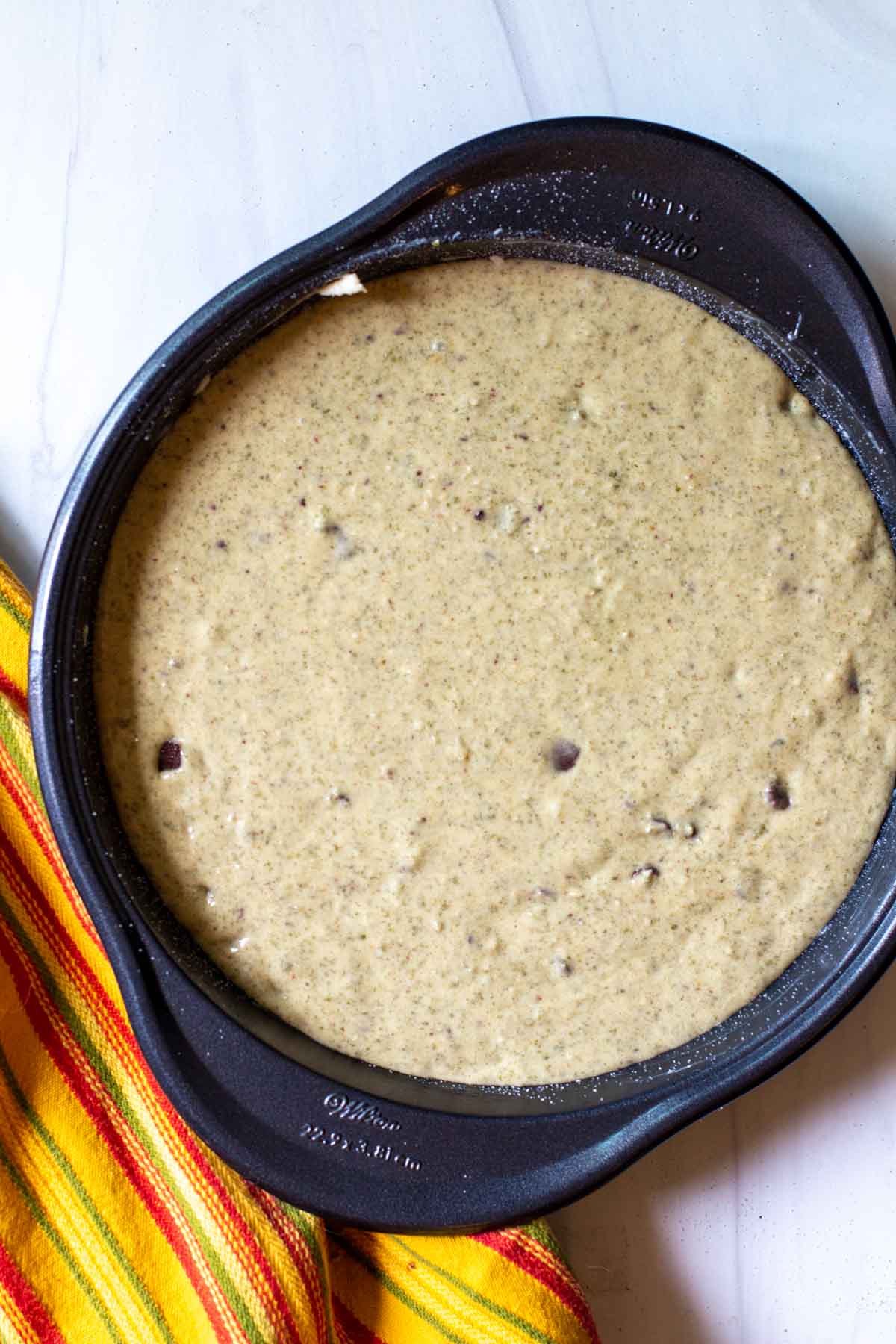 Mexican chocolate cake batter in a round cake pan.