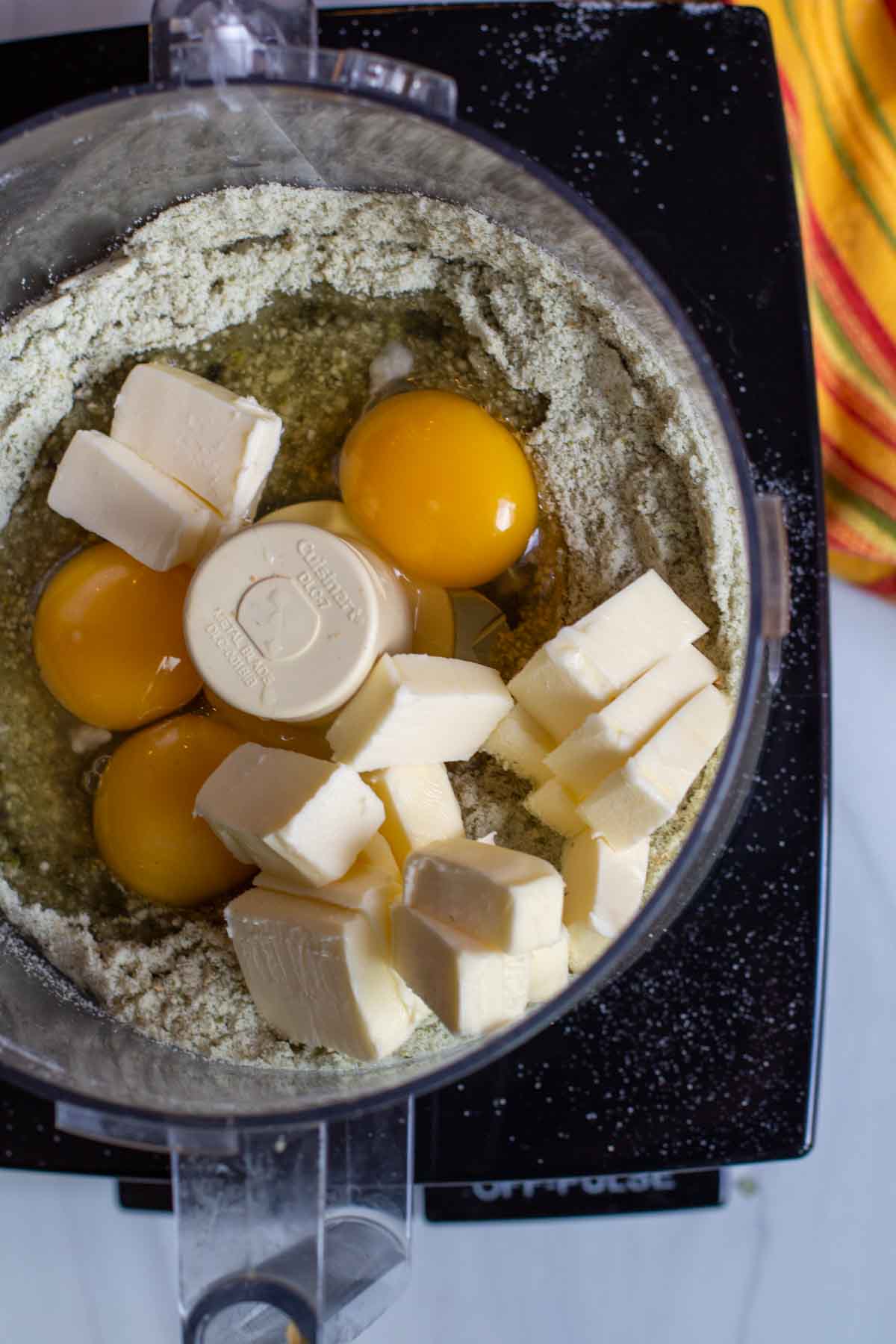 Adding butter and eggs to make a batter for Mexican Chocolate Cake.