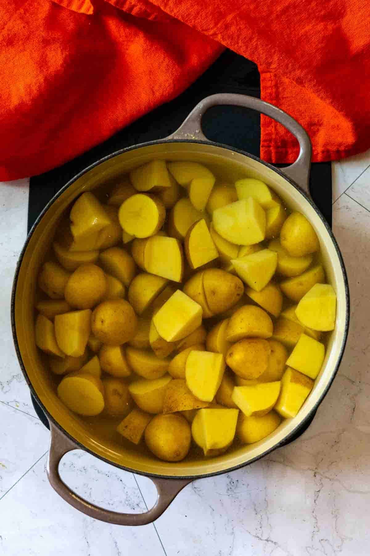 Step 2: Cooking potatoes to make potato salad with bacon.
