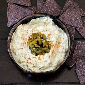 Hatch green chile dip served with blue corn tortilla chips.