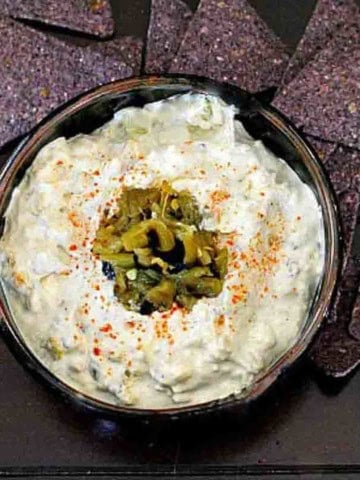 Hatch green chile dip served with blue corn tortilla chips.