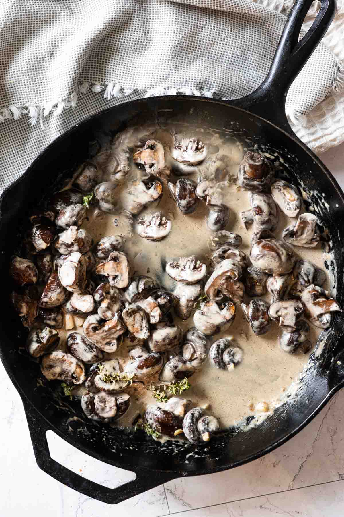 Step 3, adding mushrooms to cognac cream sauce.