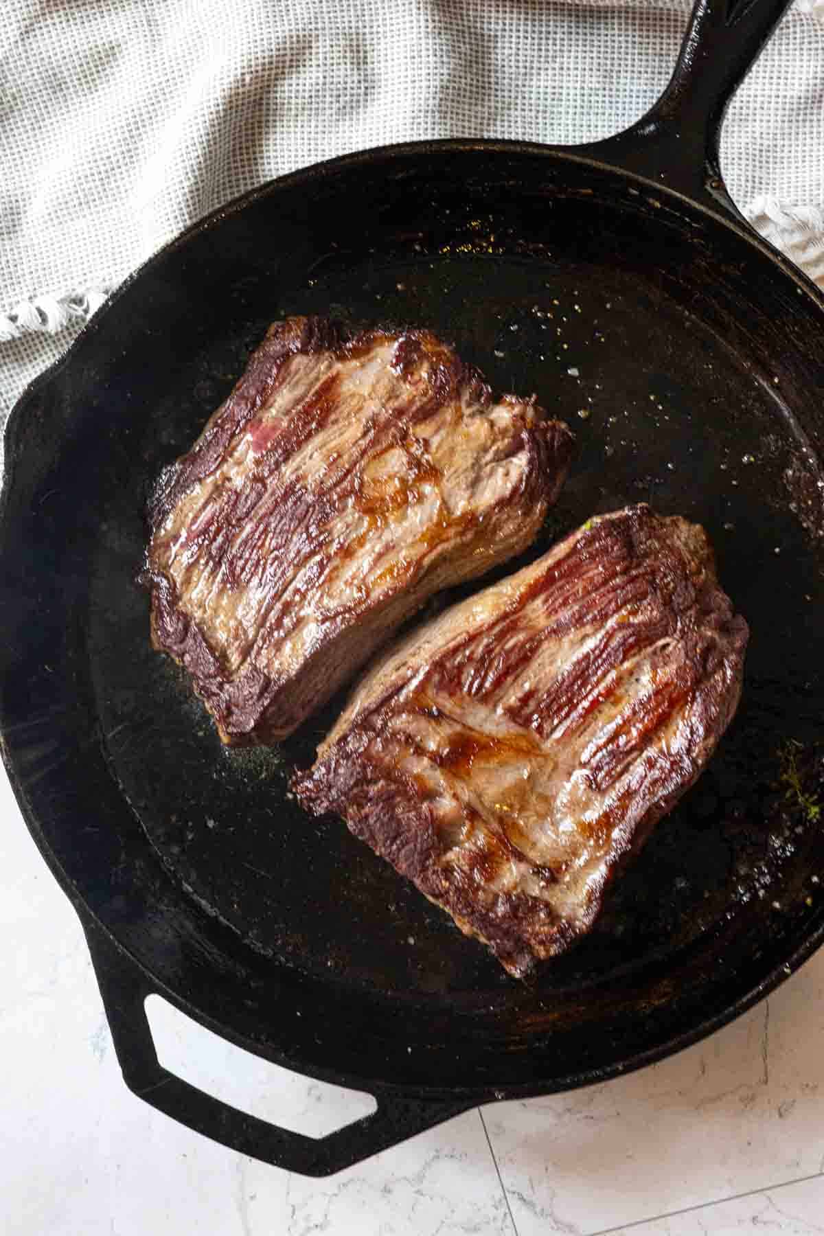 Pan searing bavette steaks in cast iron skillet.