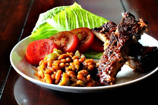 Spicy Baked Beans served with sliced tomatoes and ribs.