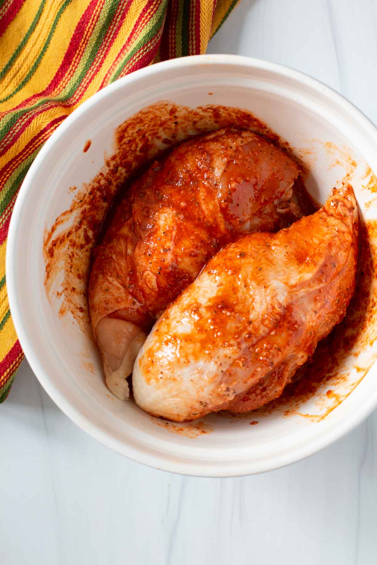 Chicken breasts marinating in achiote sauce.