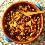 Calico baked beans served in a terra cotta bowl.
