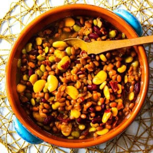 Calico baked beans served in a terra cotta bowl.