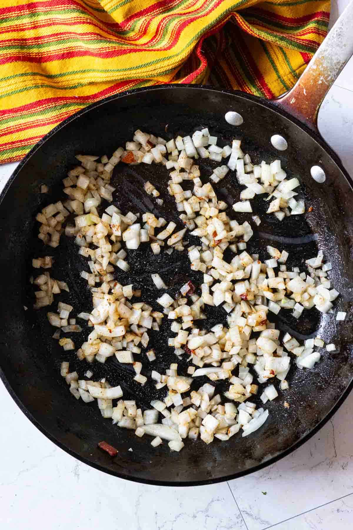 Step 2: Cooking chopped onions to make calico beans.