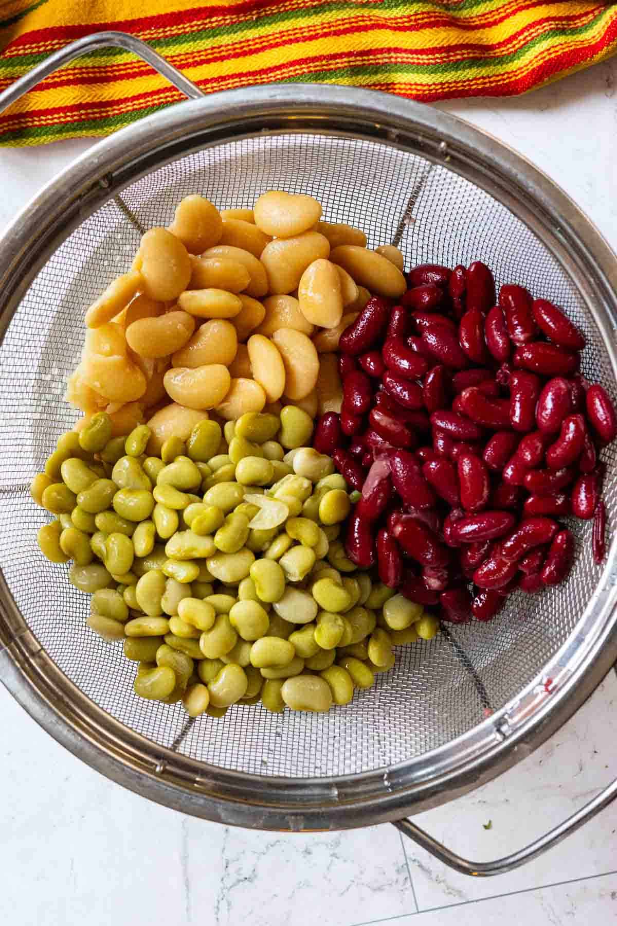 Draining canned beans to make calico beans.