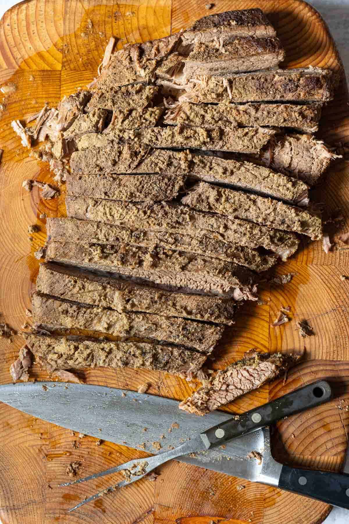 Slicing oven brisket across the grain.