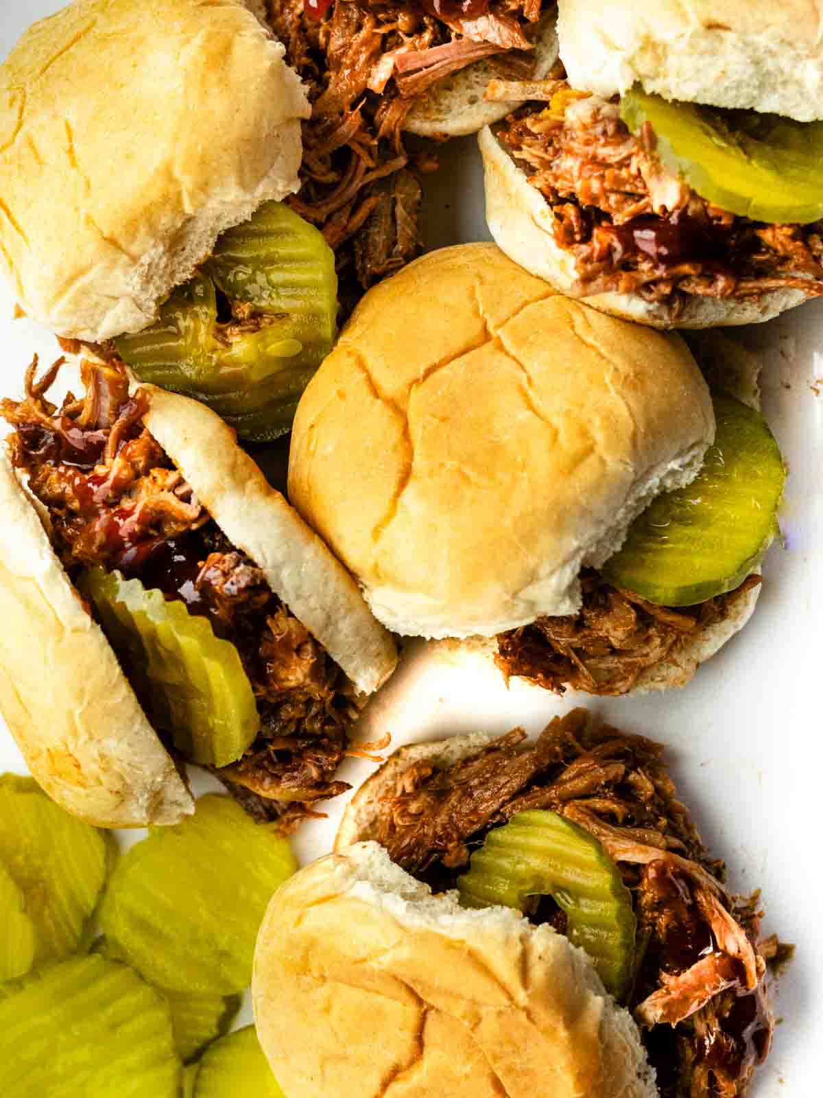Dr. Pepper bbq pulled pork sliders on a white platter.