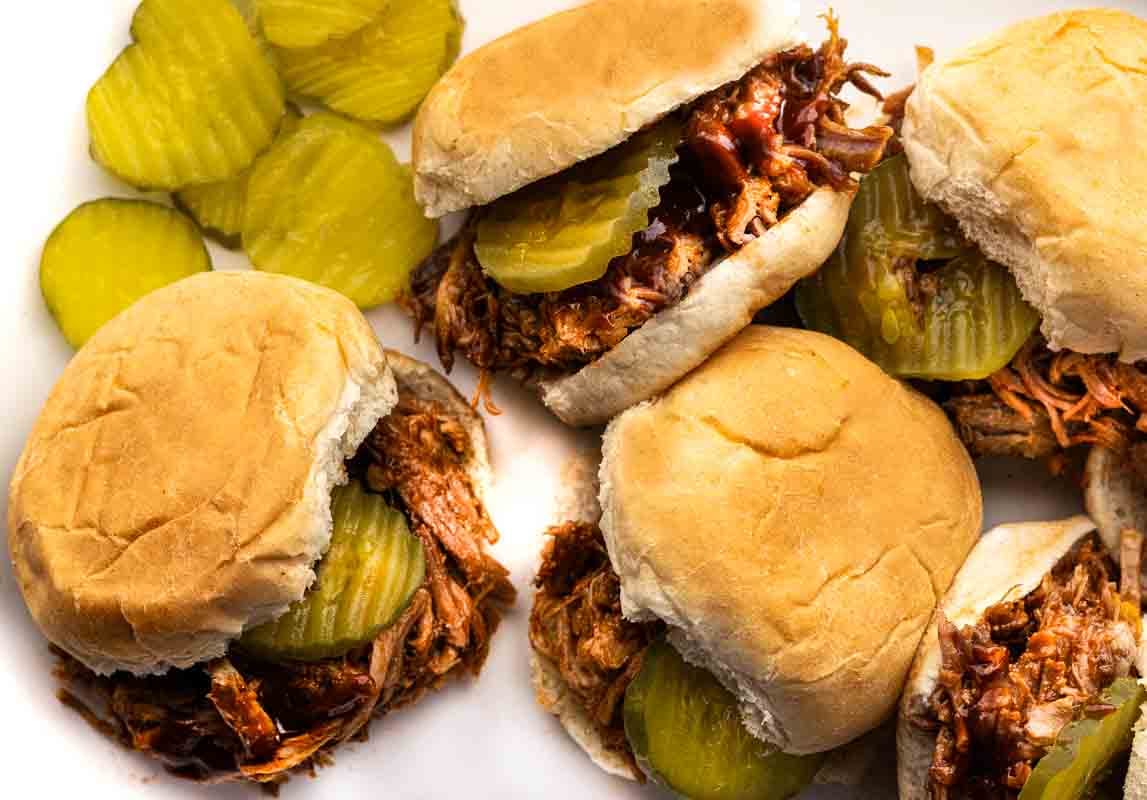 Dr. Pepper bbq pulled pork sliders on a white platter.