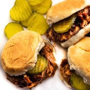 Dr. Pepper bbq pulled pork sliders on a white platter.