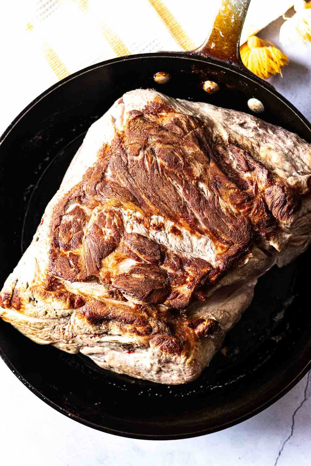 Searing a boston butt pork shoulder roast to make pulled pork sliders.