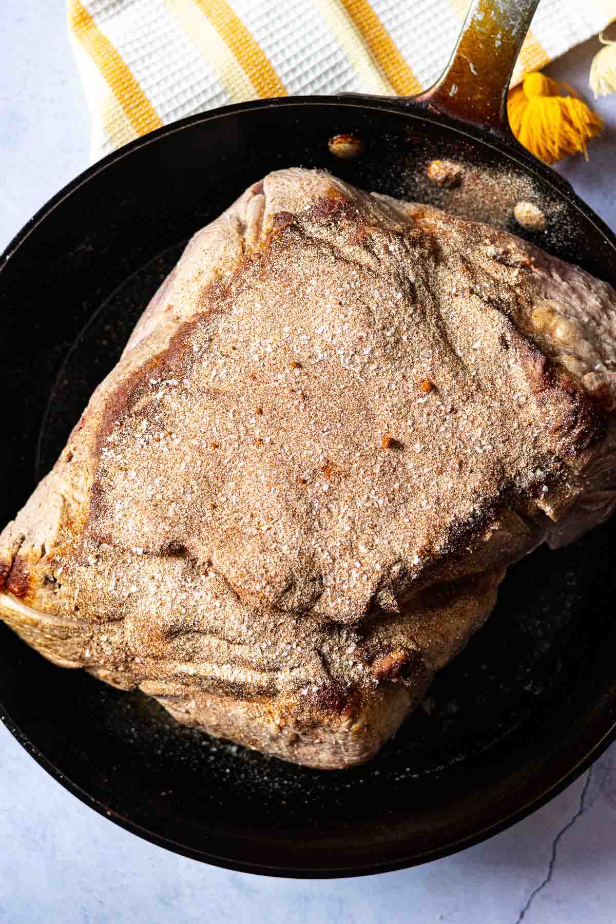 Step 3: Sprinkling the pork shoulder roast with seasoning mix.