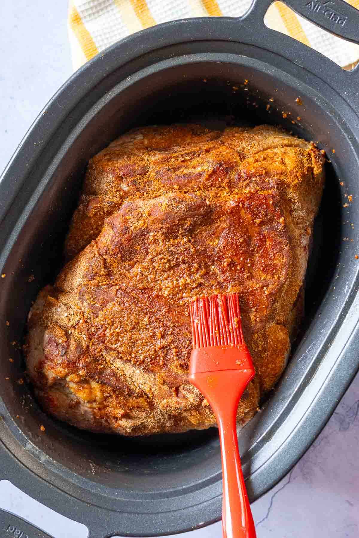 Step 5: placing pork roast in crockpot to make pulled pork sliders.