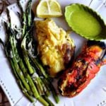 Broiled Lobster Tails served with asparagus and baked potato.