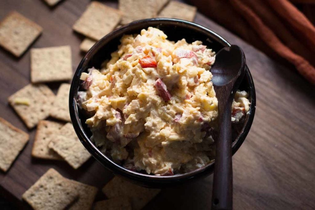Dubliner Cheese Spread Recipe surrounded by wheat thin crackers.