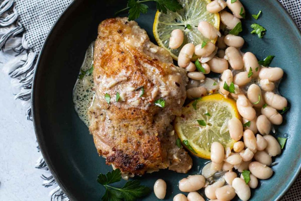 Pan fried chicken thighs with rosemary white beans.
