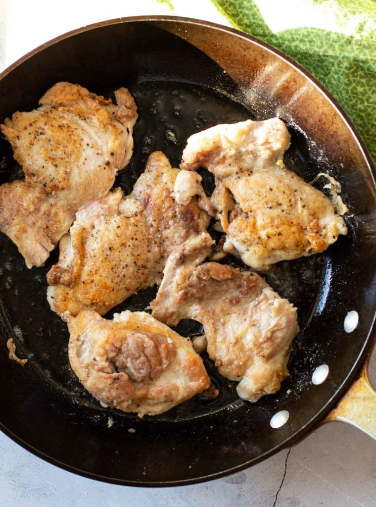 Frying boneless skinless chicken thighs in a heavy skillet.