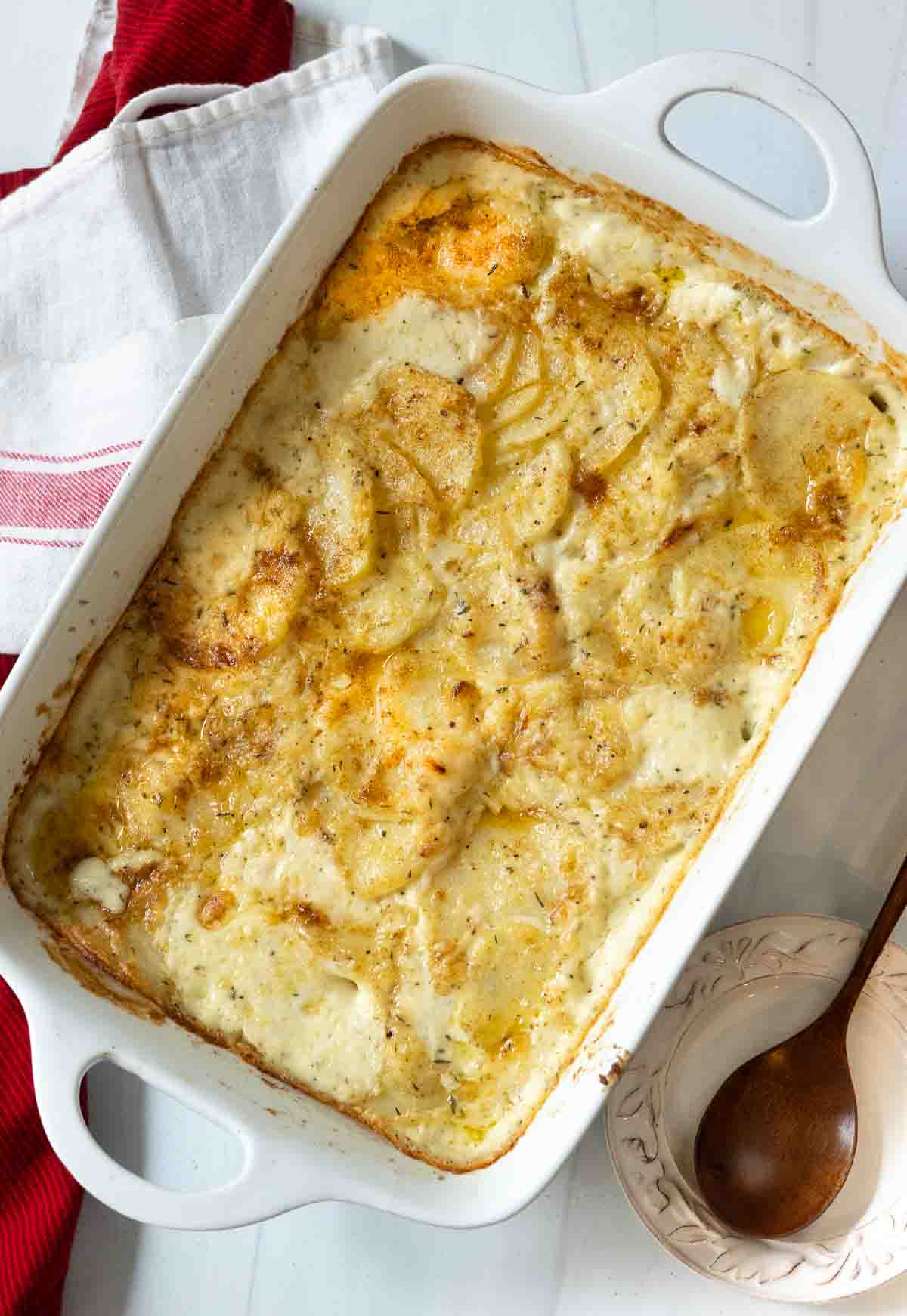 Baked gluten free scalloped potatoes in a casserole dish.