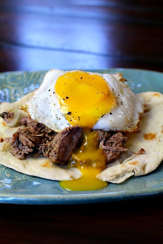 Beef Machaca Huevos. Mexican shredded beef is served on a flour tortilla and topped with an egg.
