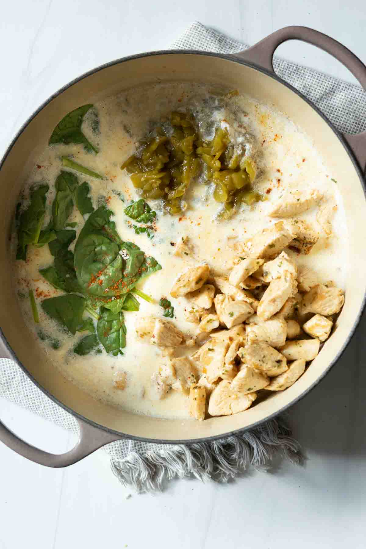 Ingredients in a Dutch oven to make Hatch chile pasta with chicken.