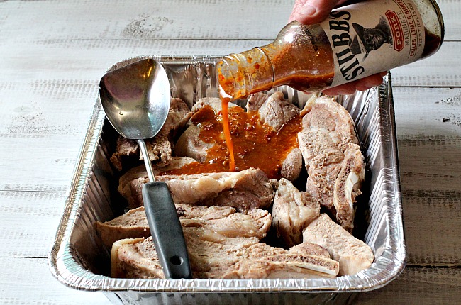 Country style pork ribs in a disposable pan using stubbs pork marinade