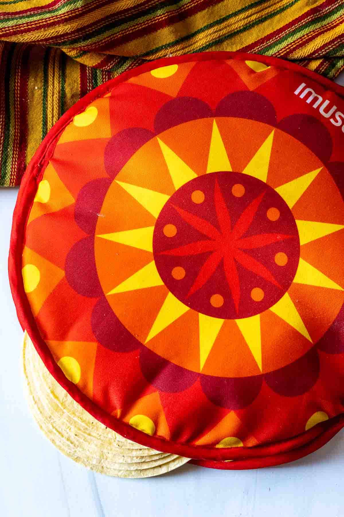 Warming corn tortillas to make fried tacos.