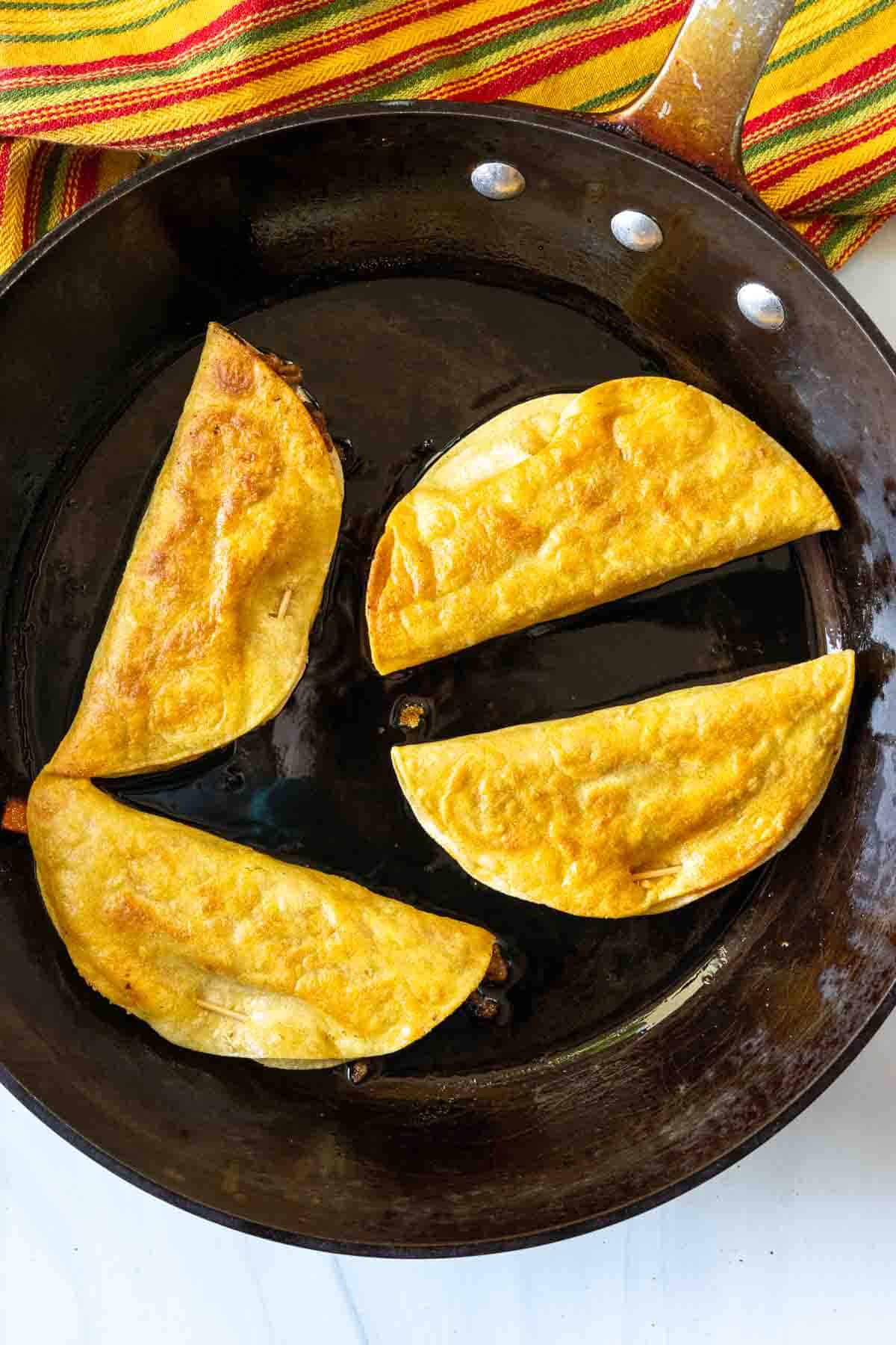 Pan frying ground beef tacos.