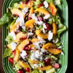 Peach salad with butter leaf lettuce, cheese, cherry tomatoes and pistachio dressing.