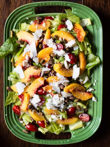 Peach salad with butter leaf lettuce, cheese, cherry tomatoes and pistachio dressing.