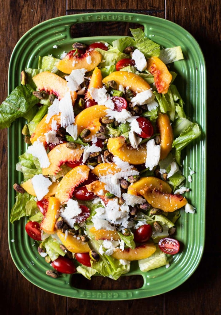 Peach salad with butter leaf lettuce, cheese, cherry tomatoes and pistachio dressing.