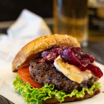 Brie Burgers with lettuce and tomato topped with red onion marmalade.