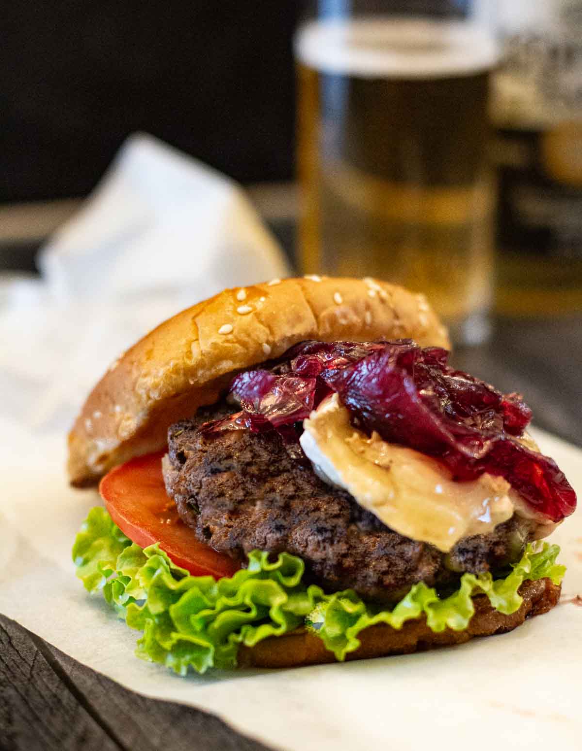 Brie Burgers with lettuce and tomato topped with red onion marmalade.