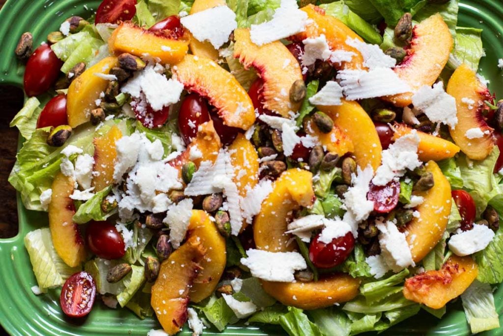 Fresh peach salad with lettuce, manchego cheese and tomatoes.