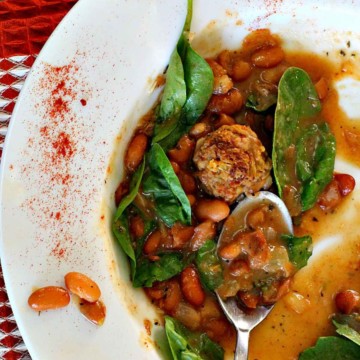Mexican chorizo meatball soup with spinach and beans.