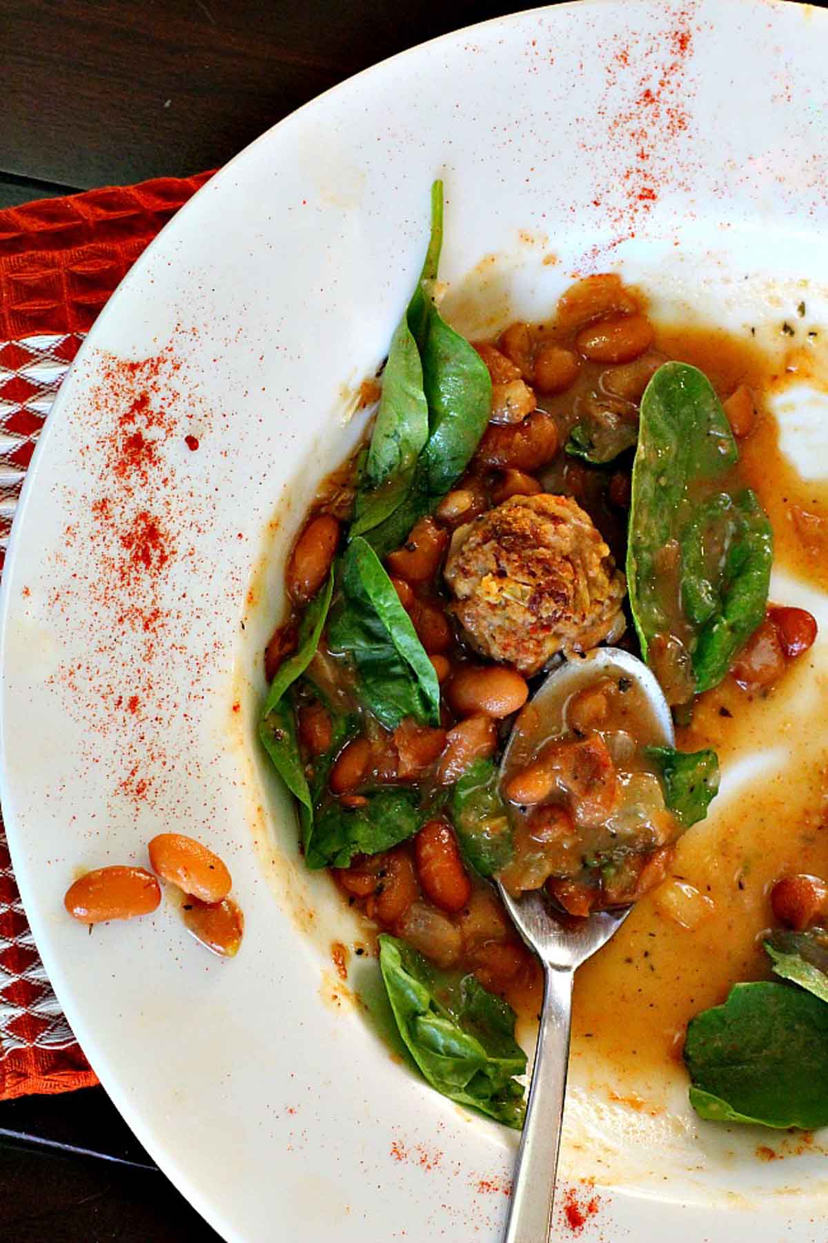 Mexican chorizo meatball soup with spinach and beans.