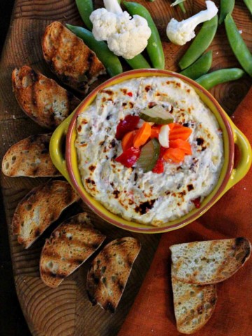 Elways restaurant artichoke dip with cream cheese, vegetables and toast.