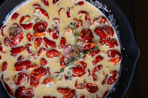 Cherry tomatoes cooking in cream sauce.