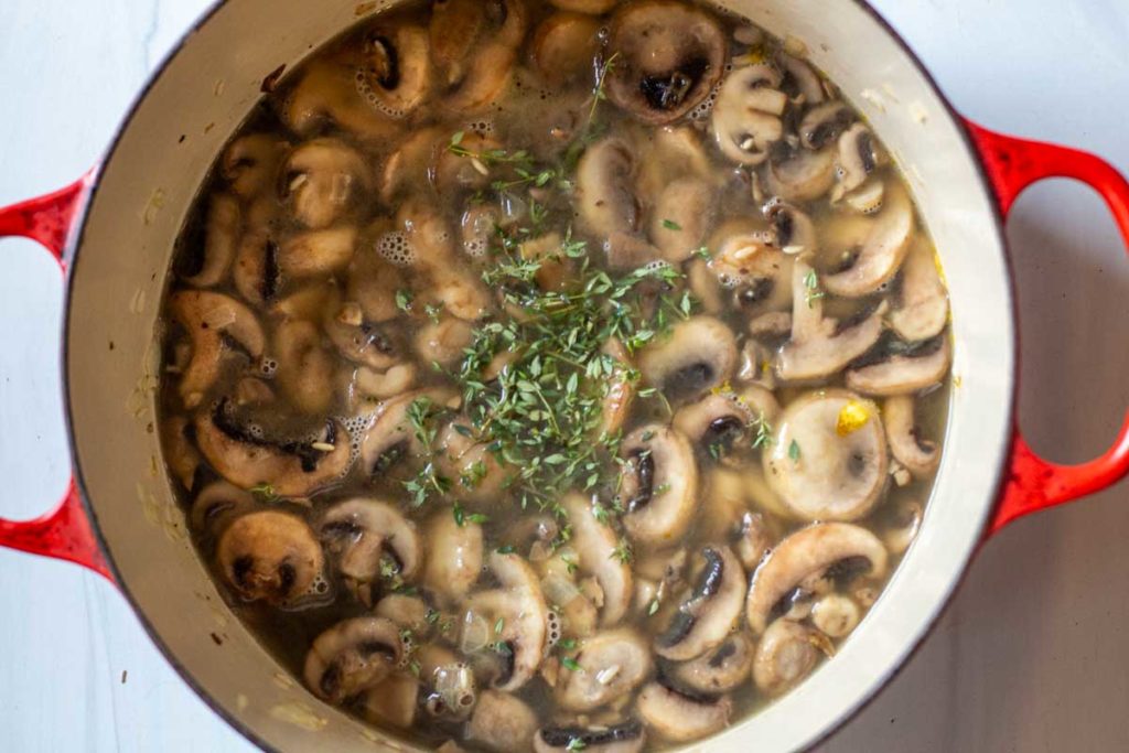 Adding broth to make mushroom soup without cream.