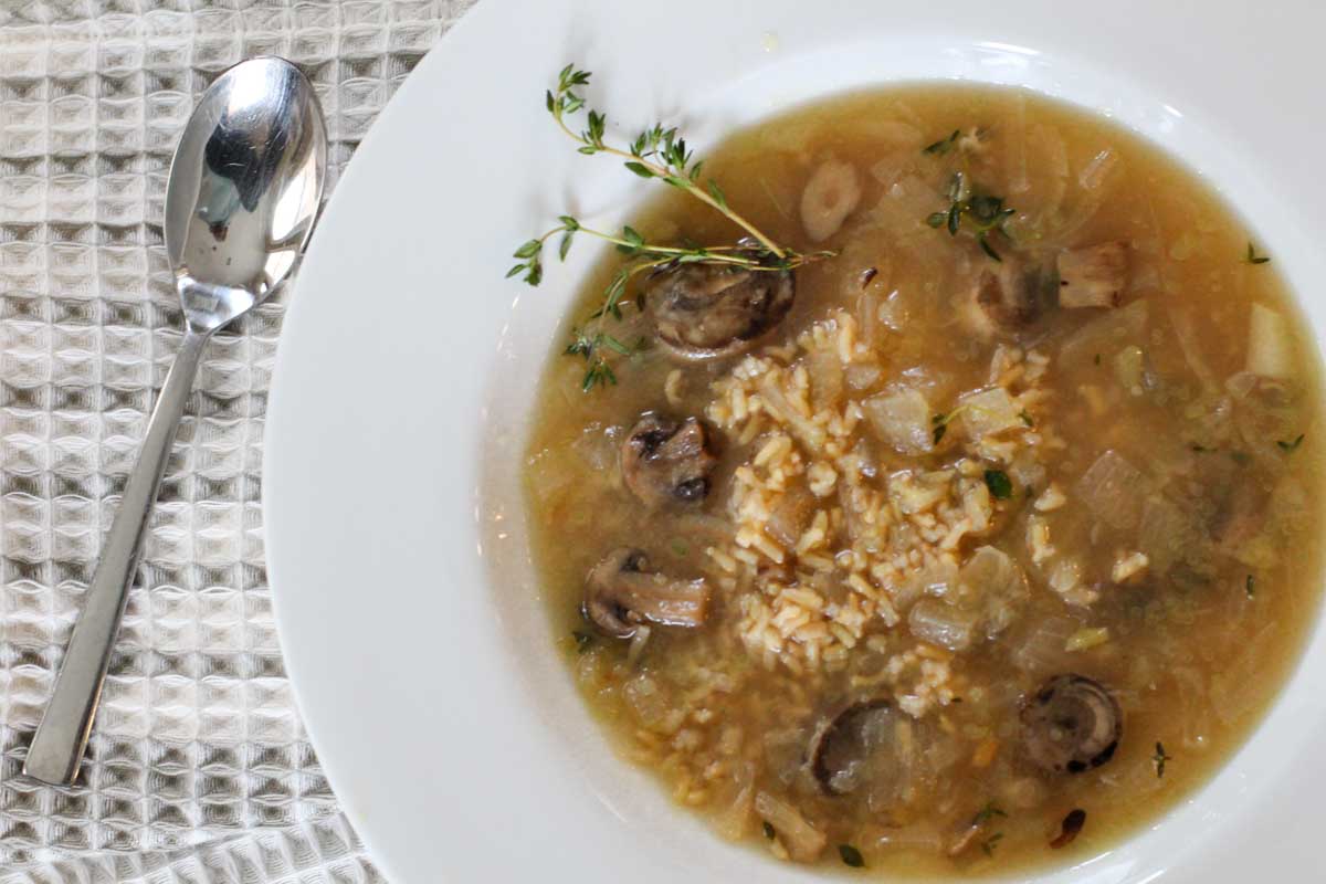 Mushroom soup with brown rice garnishes with thyme