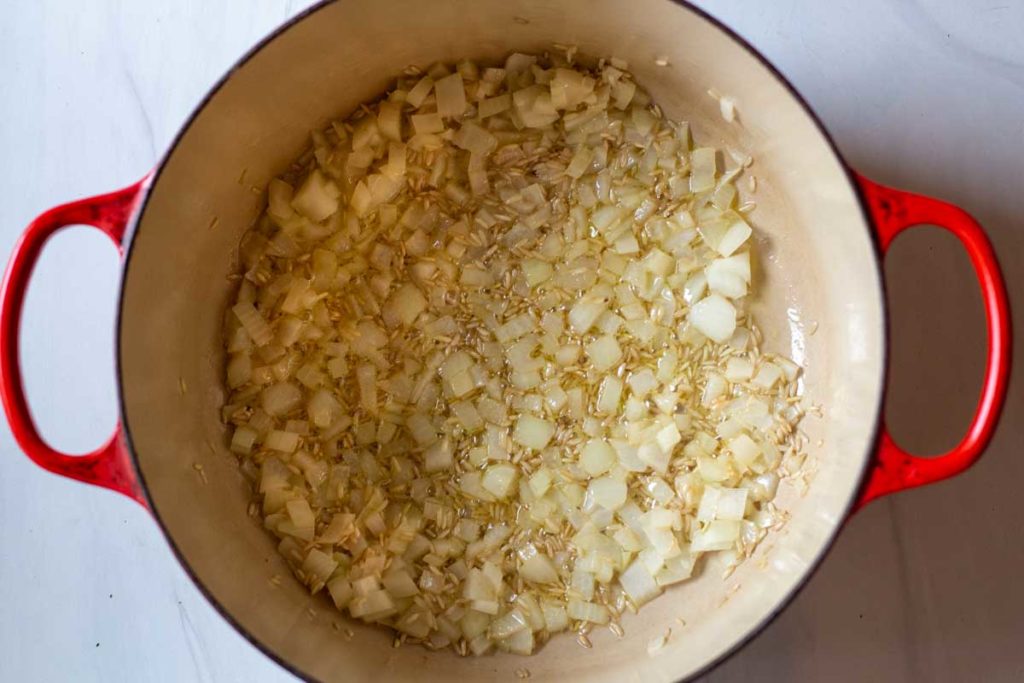cooking onions and brown rice for mushroom soup