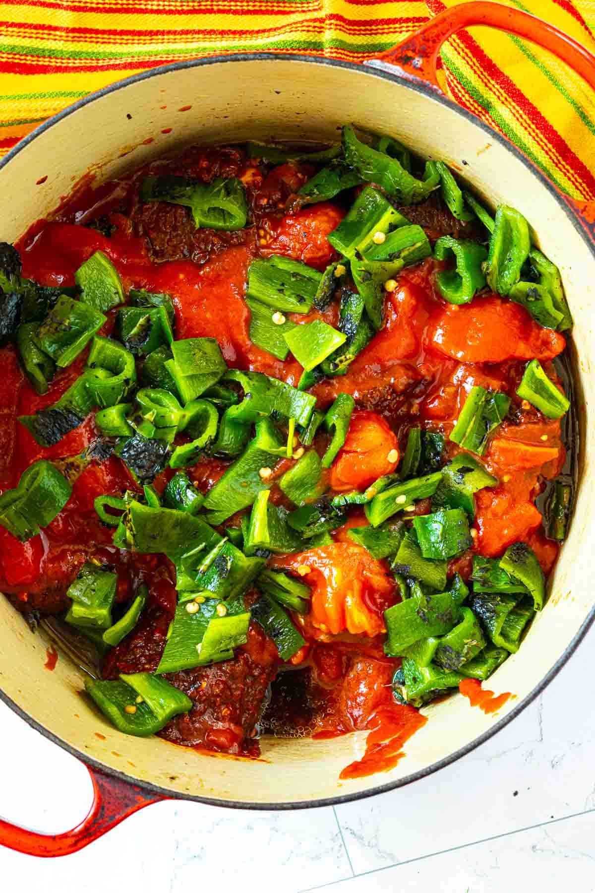 Adding poblano peppers and tomatoes to pot roast to make Mexican Pot Roast.